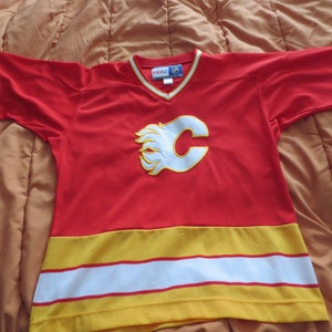 Brand New CCM National Hockey League Calgary Flames Hockey Jersey - Size Youth XL.  **FREE Shipping**