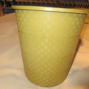 May include: A yellow plastic trash can with a checkered pattern.