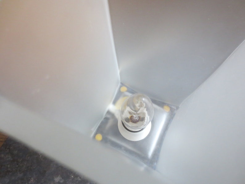 May include: A white frosted glass lampshade with a clear light bulb inside.