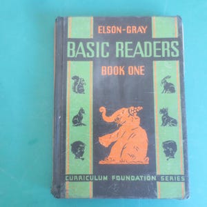 May include: Vintage "Elson-Gray Basic Readers Book One" book. The cover is black with green and orange text and illustrations of animals and children. The book is part of the Curriculum Foundation Series.