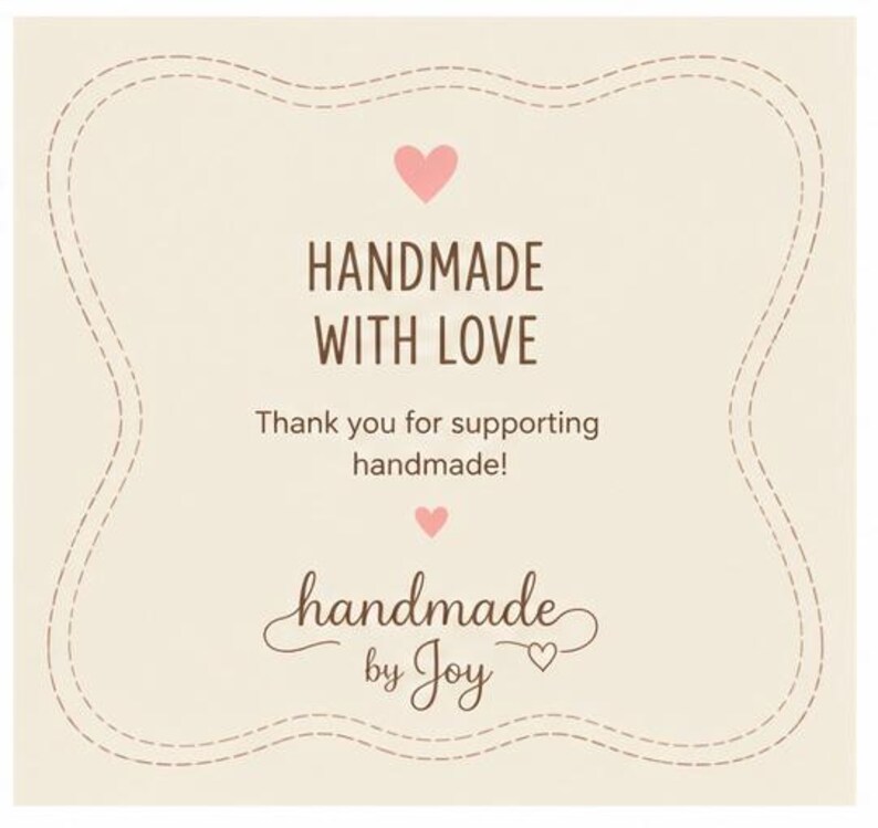May include: A cream-coloured square card with a decorative stitched border. The text "HANDMADE WITH LOVE" is in brown, with a pink heart above and below. The text "Thank you for supporting handmade!" is also included, along with "handmade by Joy".