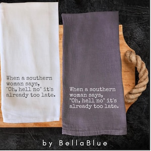 May include: Two kitchen towels, one white and one gray, with the text "When a southern woman says, 'Oh, hell no' it's already too late." The towels are displayed on a wooden cutting board.