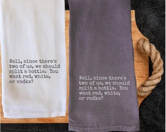 May include: Two kitchen towels, one white and one gray, with the text "Well, since there's two of us, we should split a bottle. You want red, white, or vodka?" printed in black. The towels are on a wooden cutting board.