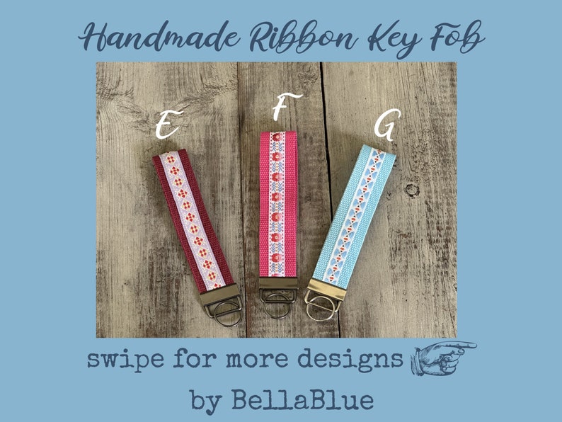 May include: Three handmade ribbon key fobs with different designs. One is burgundy with a white and orange pattern, another is pink with a floral pattern, and the third is light blue with a white and orange pattern. The text "Handmade Ribbon Key Fob" is at the top.