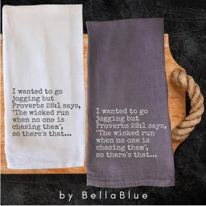 May include: Two kitchen towels, one white and one gray, with humorous text. The text reads "I wanted to go jogging but Proverbs 28:1 says, 'The wicked run when no one is chasing them', so there's that..." by Bella Blue.