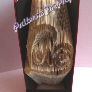 Book folding pattern for the word LOVE making a HEART