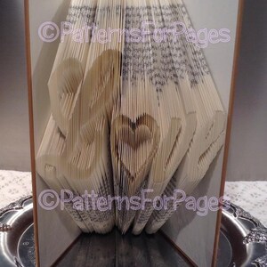Book folding pattern for LOVE in a fancy font