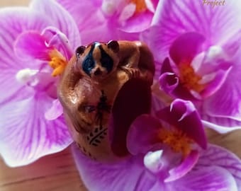 Slow loris hand-carved ring featuring red calliandra flower with black leaves decorative painting on band - sustainable