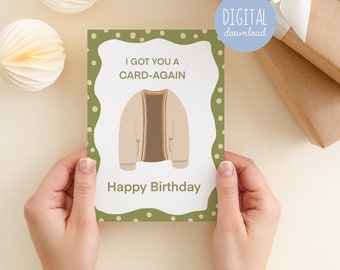 May include: A green card with white polka dots and the text "I got you a card-again Happy Birthday". A cartoon illustration of a brown cardigan is in the center of the card.