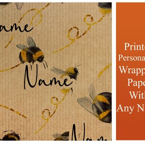 May include: Beige wrapping paper with a repeating pattern of bumblebees and yellow lines. The text "Name" is written in black cursive on the paper. Printed Personalised Wrapping Paper With Any Name.