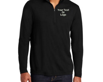 May include: A black long-sleeve pullover featuring a quarter-zip neckline and a stand-up collar. The chest area displays the white printed text "Your Text Or Logo" positioned on the left side. The garment has a smooth texture and long sleeves.