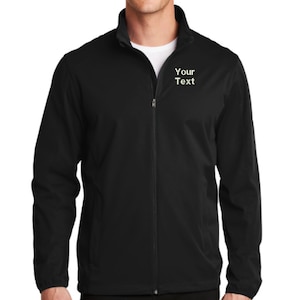 May include: A black full-zip jacket with a mock neck collar and long sleeves. The left chest area features the white embroidered text "Your Text". The jacket is constructed with a central zipper closure and a smooth, solid black fabric finish.