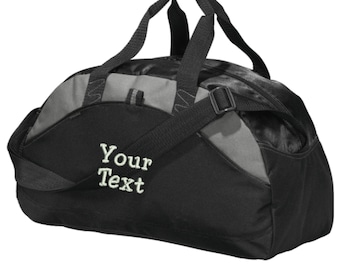 May include: A black and gray duffel bag featuring two top handles and an adjustable shoulder strap. The front panel displays the embroidered text Your Text in a light-colored font. The bag has a zippered main compartment and side pockets.