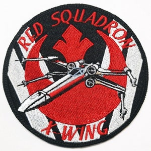 May include: A red and white embroidered patch with a black background. The patch features a red Rebel Alliance symbol with a white X-Wing fighter flying through it. The text "RED SQUADRON X-WING" is written around the symbol.