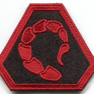 May include: A red embroidered scorpion design on a black hexagonal patch with a red border.