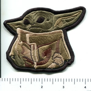 Puede incluir: Parche bordado de un personaje verde, marrón y beige con orejas grandes, que se asemeja a un personaje ficticio popular. El parche mide aproximadamente 7,6 cm de ancho.