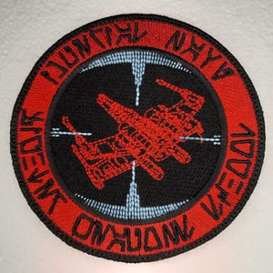 May include: Red and black embroidered patch with a red X-Wing fighter in the centre. The text around the edge reads "DON'T GIVE UP THE SHIP" and "NYYYA".