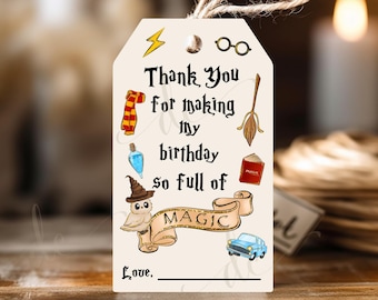 May include: A white thank you tag with a whimsical Harry Potter theme. It features a cartoon owl, a magic wand, a book, a scarf, a potion bottle, and glasses. The text reads "Thank you for making my birthday so full of magic. Love."