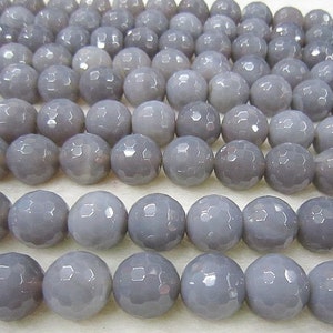 May include: A strand of gray faceted agate beads. The beads are round and have a smooth, polished finish.