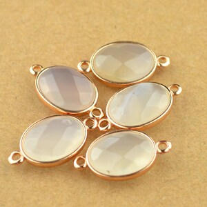 May include: Five oval-shaped white agate gemstone pendants with rose gold-toned metal settings and jump rings.
