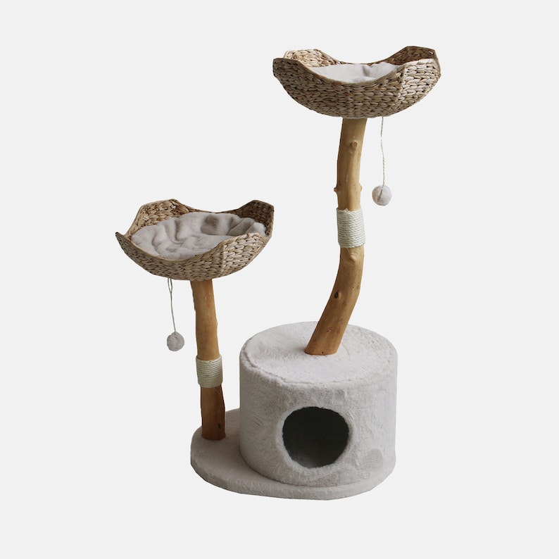May include: A two-tier cat tree with a natural wood base and two woven baskets. The tree is beige in colour and features a round opening in the base for cats to enter.