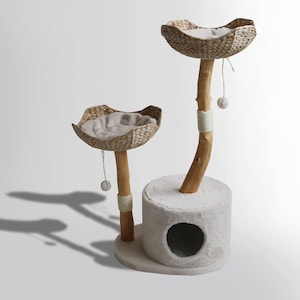 May include: A two-tier cat tree with a natural wood base and two woven baskets. The baskets are lined with soft, beige fabric. The tree has a small, round opening in the base for cats to play in.