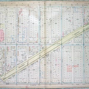 May include: A vintage map of a city block, featuring streets, buildings, and lot numbers. The map includes the text "Broadway" and "Tenth Ave." in a detailed, hand-drawn style. The map is printed on aged paper with a faded appearance.