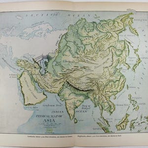 May include: A vintage physical map of Asia printed on paper, featuring green lowlands and buff-colored highlands. The map displays geographical features including the Himalayan Mountains, the Arabian Sea, and the Indian Ocean, with text labels.