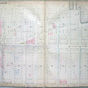 May include: A vintage map of a city grid, featuring streets labeled Tenth Ave, Eleventh Ave, and Twelfth Ave. The map is divided into numbered blocks, with some areas highlighted in pink. The map is labeled "Plate C."
