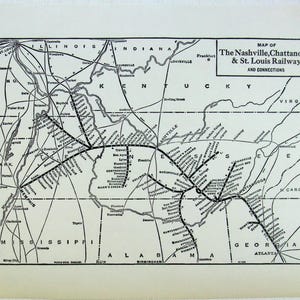 May include: A vintage black and white map of the Nashville, Chattanooga & St. Louis Railway and connections. The map shows the railway lines and the cities they connect, including Nashville, Memphis, and Atlanta. The map is printed on a cream-coloured paper.