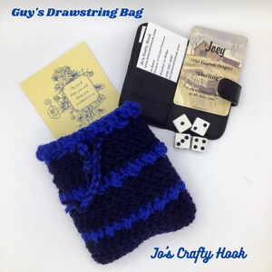 May include: A blue and black crocheted drawstring bag with a white cord. The bag is sitting on a white surface with a business card and a card with the name "Joey" on it.