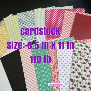 May include: A stack of patterned cardstock in various colors, including red, green, blue, and yellow. The cardstock is 8.5 inches by 11 inches and 110 lb weight. The text "cardstock" and "size: 8.5 in x 11 in 110 lb" is visible on the cardstock.