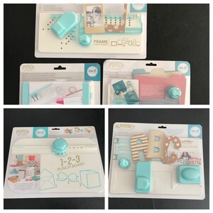 May include: Four We R Memory Keepers punch boards for crafting. The boards are white with blue accents and feature different punch designs, including a frame, alphabet, 1-2-3, and folder. Each board includes a punch tool and instructions.