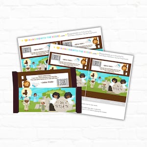 Pode incluir: Embrulho de barra de chocolate de Páscoa imprimível com uma ilustração colorida de um túmulo com anjos e o texto "Ele ressuscitou". O embrulho também inclui um versículo bíblico de João 11:25.