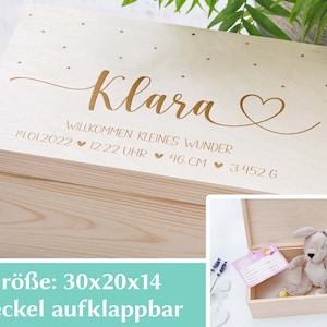 May include: A wooden keepsake box with a hinged lid, engraved with the name "Klara" and the text "Willkommen kleines Wunder 14.01.2022 12:22 Uhr 46 CM 3.452 G". The box is 30 inches by 20 inches by 14 inches.