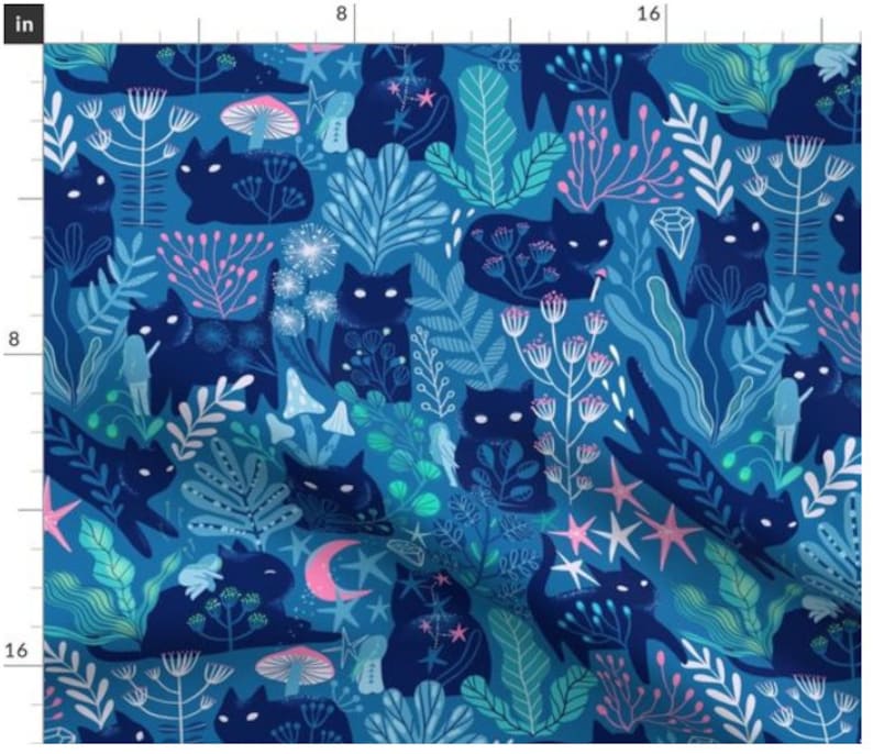 May include: A blue fabric with a repeating pattern of black cats, stars, mushrooms, and flowers. The background is a deep blue color, and the cats are outlined in black. The stars are white and the mushrooms are pink and white.