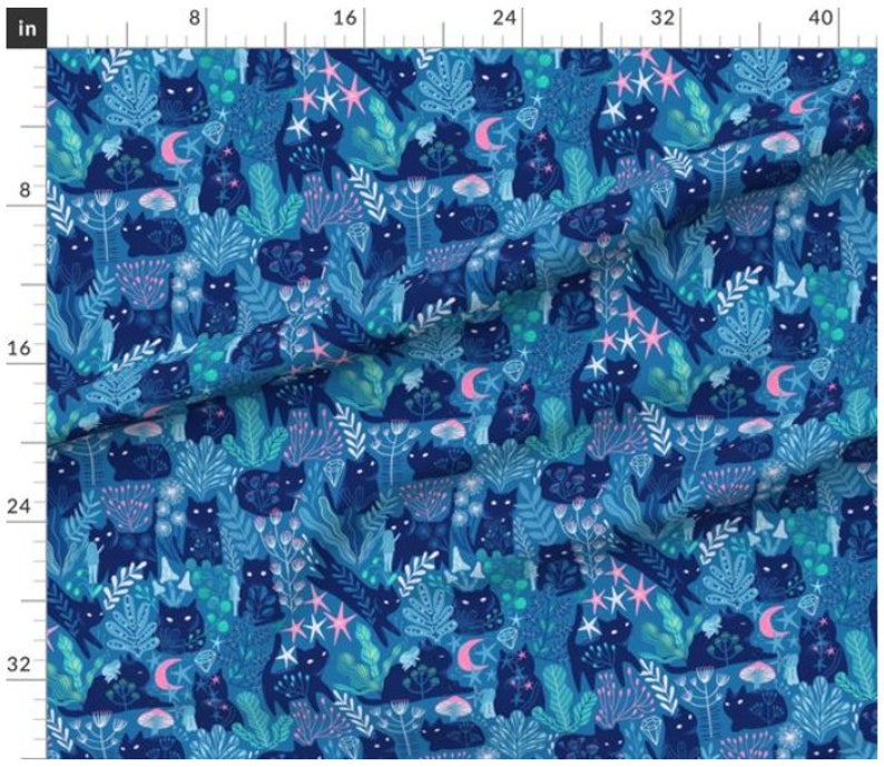 May include: A blue fabric with a repeating pattern of black cats, stars, moons, and flowers. The fabric is perfect for crafting projects, quilting, and home decor.