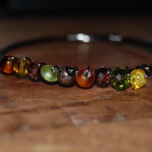 Wire wrapped beaded bracelet, gunmetal with multi-colored beads in shades of autumn
