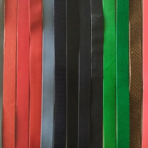May include: A variety of leather strips in different colors and textures, including red, green, black, brown, and gray.