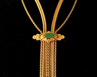 May include: A gold chain necklace with a green stone pendant. The necklace has a tassel-like design with multiple strands of chain.
