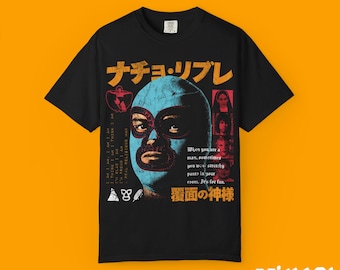 May include: Black t-shirt featuring a luchador mask in blue and a graphic design with text in Japanese and English. The shirt has the words "Nacho Libre" in orange and a series of images and text.