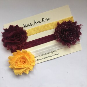 Puede incluir: Tres juegos de cintas para el pelo con flores de tela. Las flores son amarillas, burdeos con lunares blancos y burdeos. Las cintas para el pelo son amarillas, burdeos y blancas. La tarjeta dice "Miss Ava Rose" e incluye el sitio web y el nombre de usuario de Instagram de la tienda.