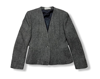 May include: A dark grey blazer with a herringbone pattern and a single button closure.