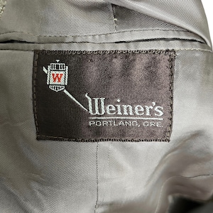 May include: A brown label with white text that reads "Weiner's Portland, Ore." and a red and white crest with a "W" inside.