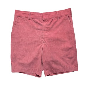 May include: A pair of pink cotton shorts with a straight leg and a button fly.