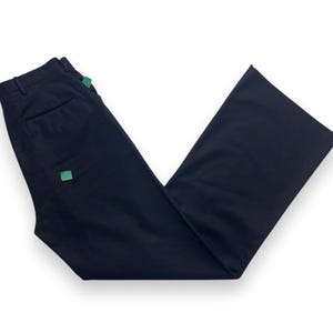 May include: Black wide-leg pants with a green square detail on the left side.