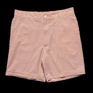 May include: Red and white striped cotton shorts with a button closure.