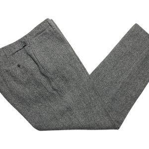 May include: A pair of gray herringbone patterned pants.