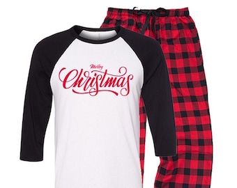 May include: Red and black plaid pajama pants with a white and black baseball style shirt that says "Merry Christmas" in red lettering.
