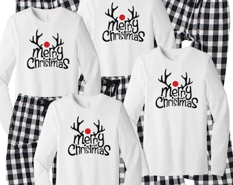 May include: A set of four white long-sleeved shirts with black reindeer antlers and the text "merry christmas" in black. The shirts are paired with black and white plaid pajama pants.
